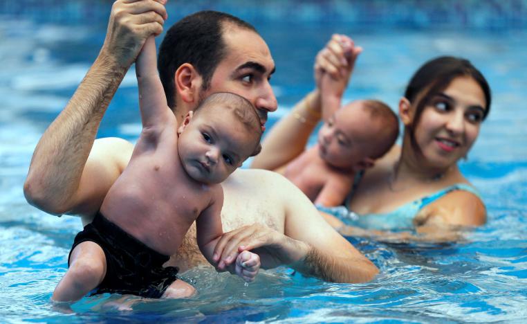 Egyptian parents teach newborns how to swim in Cairo