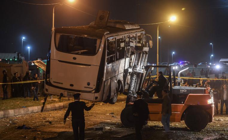 A damaged tourist bus is being removed after it was struck by a roadside bomb near the Pyramids of Giza at the district of al-Maryutia, on December 28, 2018. 