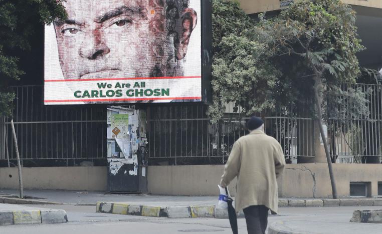 A portrait of former Nissan chief Carlos Ghosn is seen on a billboard in his support at a street in Beirut on December 6, 2018.