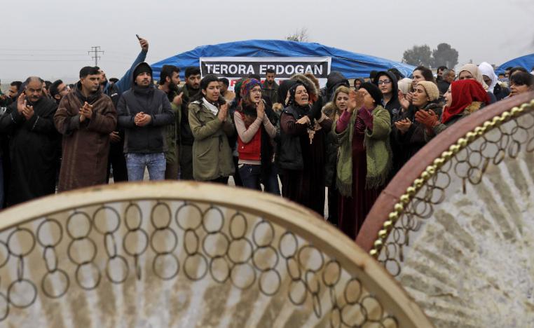 Kurdish demonstrators gather to protest near the border wall separating Turkey from Syria in the western Syrian countryside of Ras al-Ain on December 20, 2018.