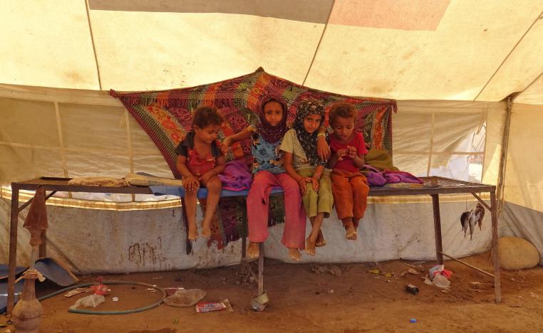 Yemeni children gather inside a tent at a camp for displaced people in the Khokha district of the western province of Hodeidah on December 12, 2018.