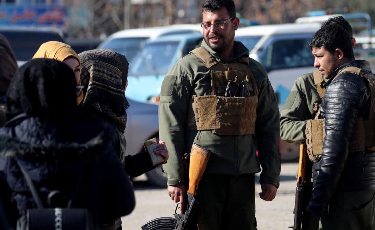 Armed men stand guard the streets in the northern Syrian town of Manbij, controlled by Kurdish-dominated Syrian Democratic Forces (SDF), on December 29, 2018.