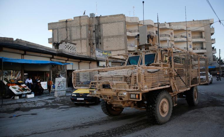 A vehicle of US troops passing on a street, in Manbij town, north Syria on March 31, 2018.