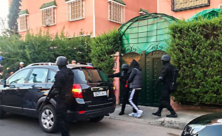 Members of the Central Bureau of Judicial Investigation (BCIJ) taking into custody one of the suspects of the hikers' murder 