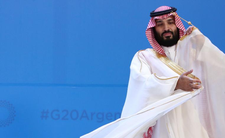 Saudi Arabia's Crown Prince Mohammed bin Salman adjusts his robe as leaders gather for the group at the G20 Leader's Summit at the Costa Salguero Center in Buenos Aires, Argentina, Friday, Nov. 30, 2018.