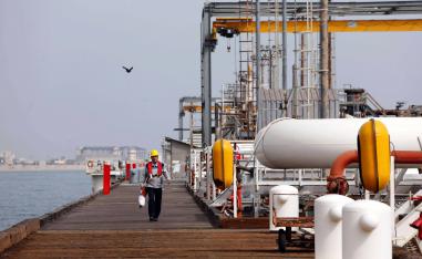An Iranian worker walks the platform of an oil facility in the Khark Island. 