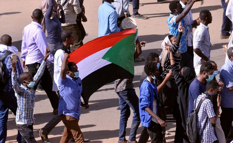 Sudanese demonstrators chant slogans as they march along the street during anti-government protests in Khartoum