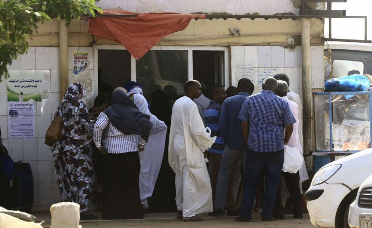 People queue in front of a bakery in the Sudanese capital Khartoum on August 26, 2018.