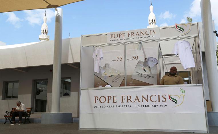 A man sells memorabilia for Pope Francis' upcoming trip to the UAE at St. Mary's Catholic Church in Dubai