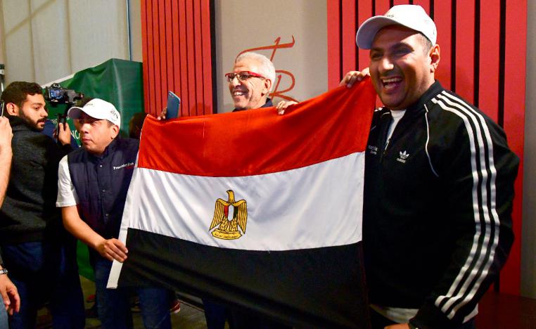 Egyptian representatives pose with their national flag as they celebrate the Confederation of African Football (CAF) executive committee's decision to choose Egypt to host the 2019 Africa Cup of Nations between June 15 and July 13, in an Hotel in Dakar on January 8, 2019.