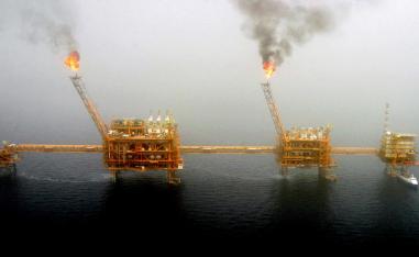 Gas flares from an oil production platform at the Soroush oilfields in the Persian Gulf, south of the Iranian capital Tehran, July 25, 2005.