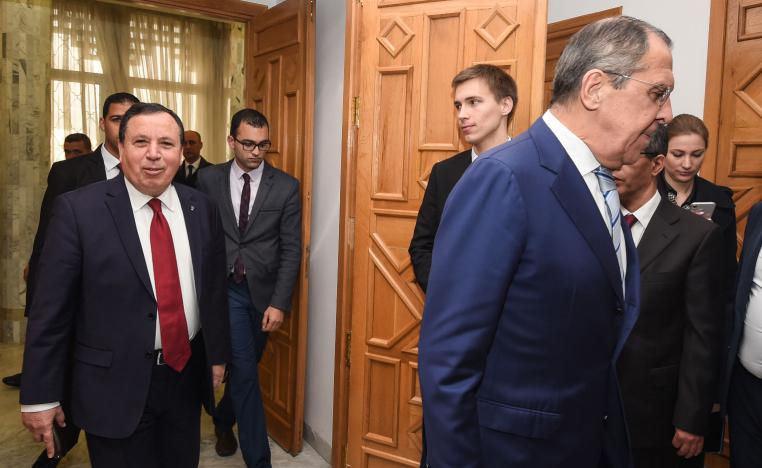 Tunisian Foreign Minister Khemaies Jhinaoui (L) arrives for a meeting with visiting Russian Foreign Minister Sergei Lavrov (R) in the capital Tunis on January 26, 2019.