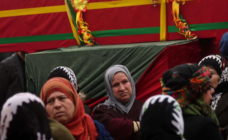 Mourners surround the coffin of a local official, who fighters from the Syrian Democratic Forces (SDF) say was assassinated in a Kurdish-held area in the countryside of Deir Ezzor, during his funeral in northeastern Syrian Kurdish-majority city of Qamishli, on December 31, 2018.