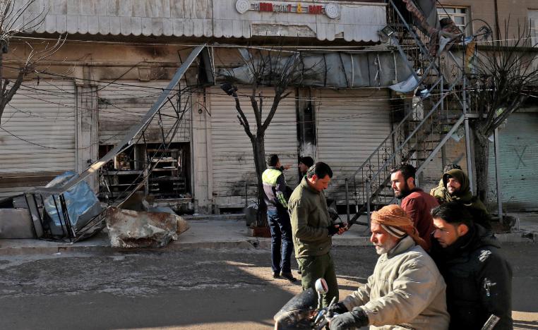 Syrians check the site a suicide attack targeting US-led coalition forces in the flashpoint northern Syrian city of Manbij which killed four US serviceman the previous day on January 17, 2019.