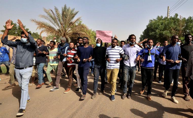 Sudanese demonstrators chant slogans as they participate in anti-government protests in Khartoum