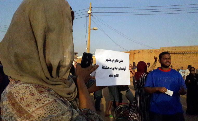 A Sudanese demonstrator carries a placard which reads in Arabic "You will leave in January, or February, no problem, as long as you are leaving," as he attends a sit-in on January 27, 2019, in the Bahri neighbourhood, north of the capital Khartoum.