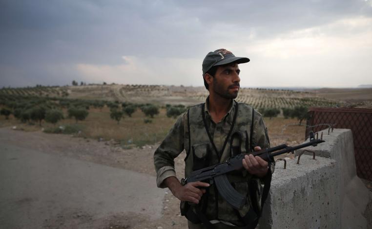 A Syrian security officer mans a checkpoint on the outskirts of Jarablus, northern Syria, Wednesday, May 30, 2018.