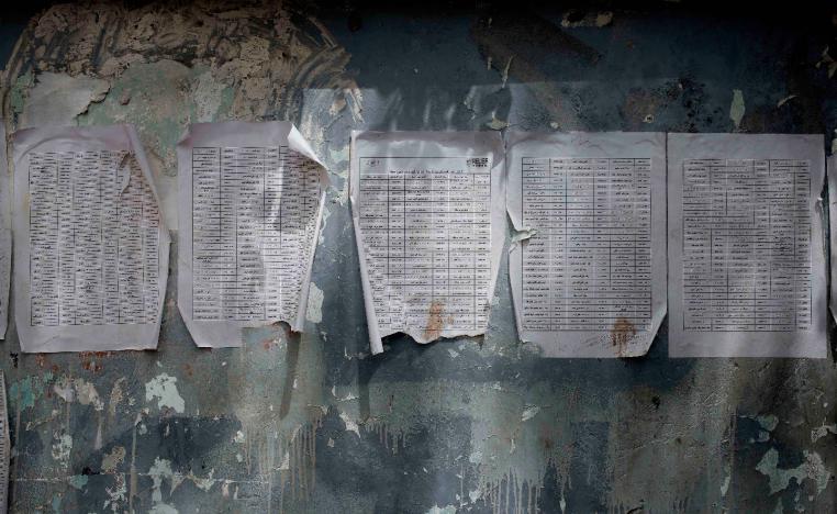 A worn-out list of registered names for aid by Relief International, part of the World Food Program, is posted in Aden, Yemen on July 23, 2018.