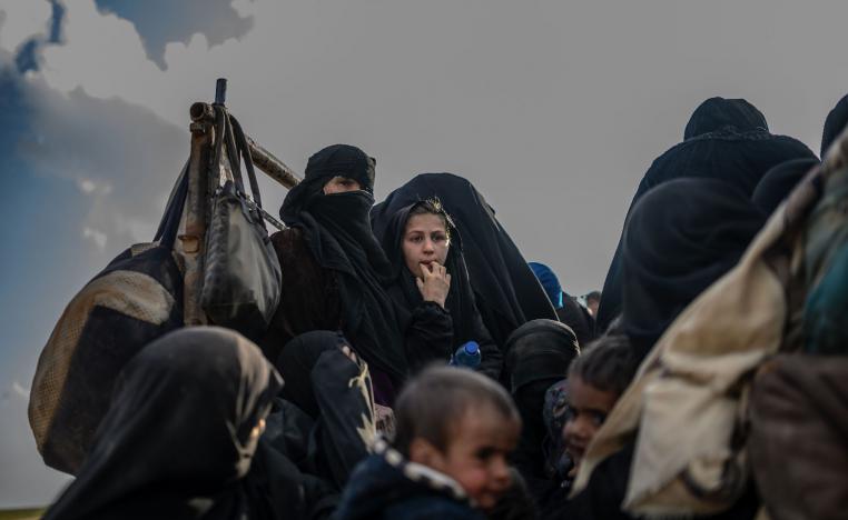 People who fled the Islamic State (IS) group's last holdout of Baghouz, in Syria's northern Deir Ezzor province, sit in a truck, on February 22, 2019.