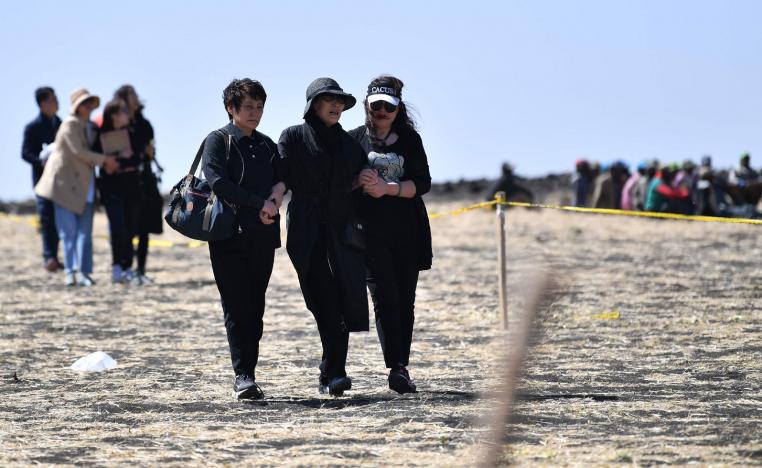 A family member of victims from China walk toward the crash site of the Ethiopian Airlines operated Boeing 737 MAX aircraft in which their relatives perished among the 157 passengers and crew onboard, at Hama Quntushele village, near Bishoftu, in Oromia region, on March 15, 2019.