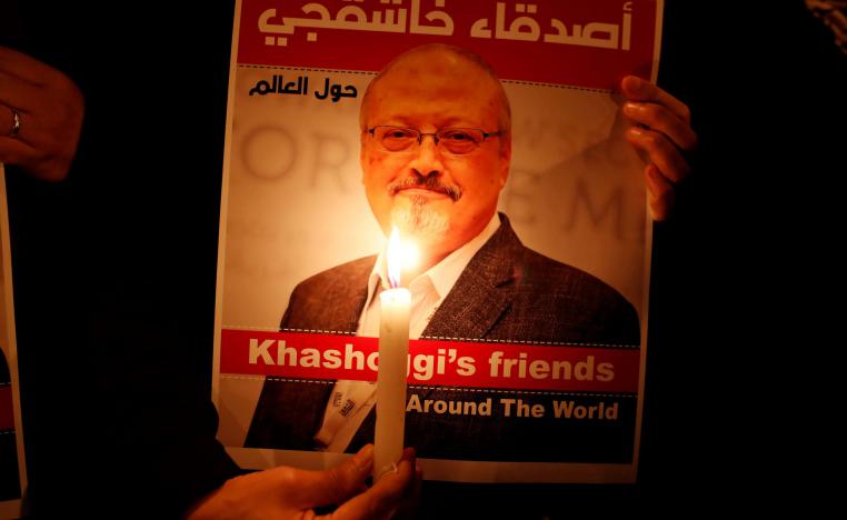 A demonstrator holds a poster with a picture of Saudi journalist Jamal Khashoggi outside the Saudi Arabia consulate in Istanbul, Turkey October 25, 2018.