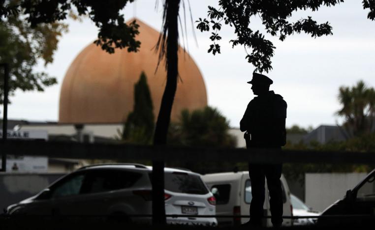 An armed policeman stands guard in front of the Masjid Al Noor Mosque in Christchurch on March 16, 2019.