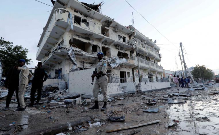 Security forces walk through rubble near damaged buildings after a suicide car bomb exploded, targeting a hotel in a business center in Maka Al Mukaram street, Mogadishu, Somalia March 1, 2019.