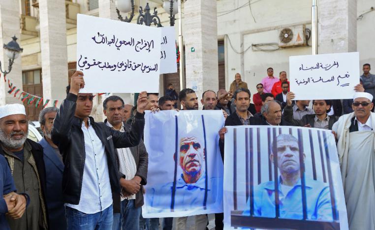 Family and tribe members of imprisoned former Libyan intelligence chief Abdullah al-Sanussi, demonstrate with signs calling for his release and showing his picture on posters, in the Libyan capital Tripoli on March 23, 2019.