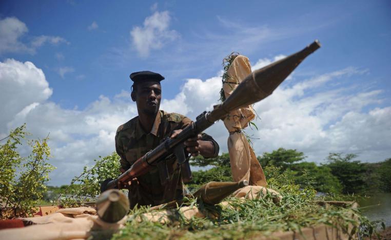 A Somali soldier holds a mortar gun at Sanguuni military base south of Mogadishu, Somalia.