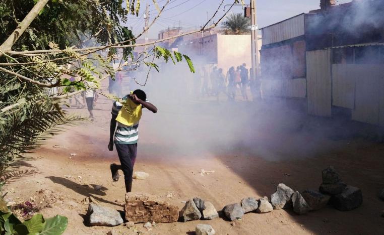 A Sudanese protester covers his face from tear gas during an anti-government demonstration in the Sudanese capital Khartoum's district of Burri on February 24, 2019.