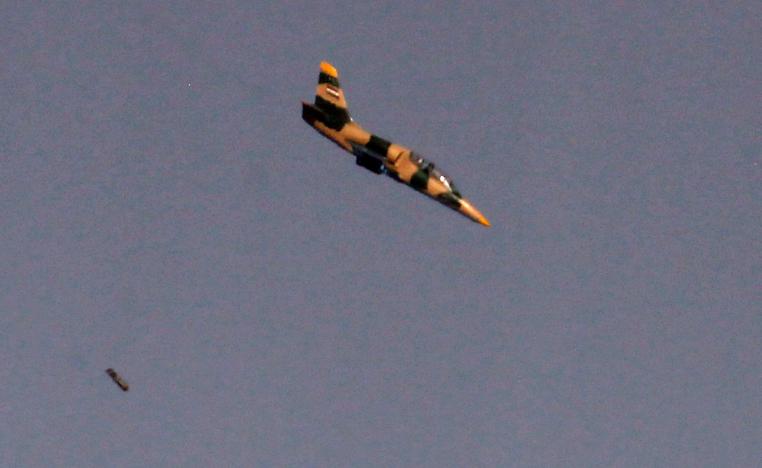 Israeli war plane dropping a payload above buildings in Syria