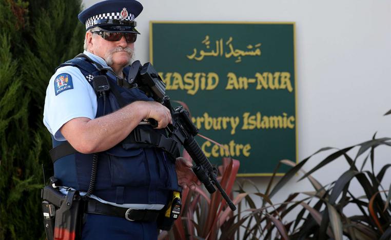 An armed police officer stands guard outside the Al Noor mosque in Christchurch 