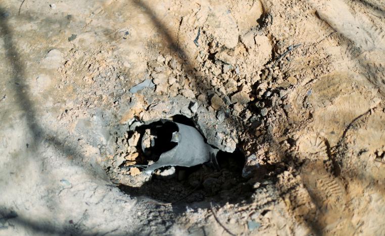 A hole made by an exploded missile is seen in Abu Salim district in Tripoli, Libya