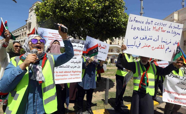 Libyan demonstrators hold signs against what they call foreign intervention in Libya