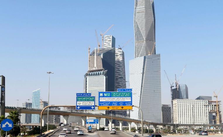 Cars drive past the King Abdullah Financial District in Riyadh
