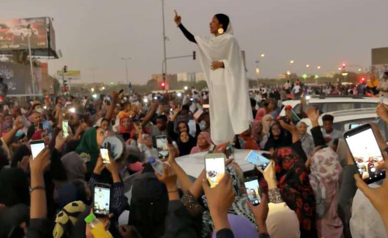 A Sudanese woman gestures during a protest demanding Sudanese President Omar Al-Bashir to step down along a bridge in Khartoum, Sudan April 8, 2019, in this still image taken from a social media video obtained on April 9, 2019.