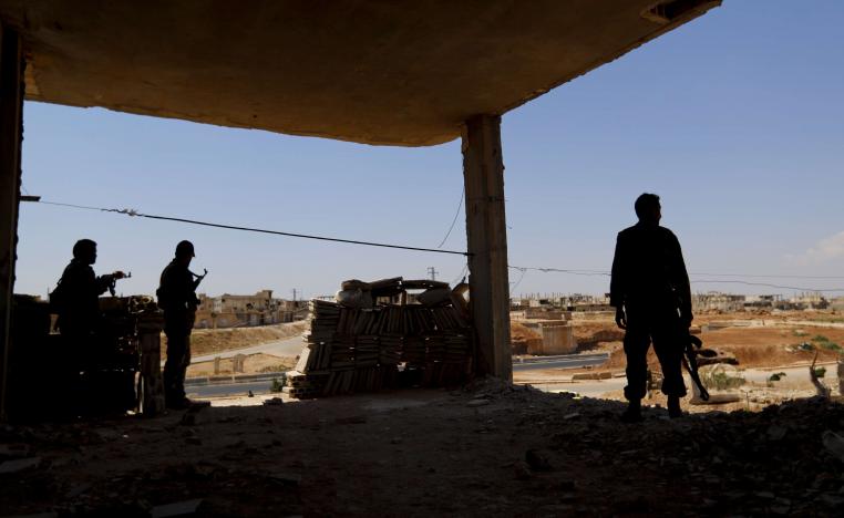 Syrian soldiers stand guard at their post overlooking the Damascus-Aleppo highway
