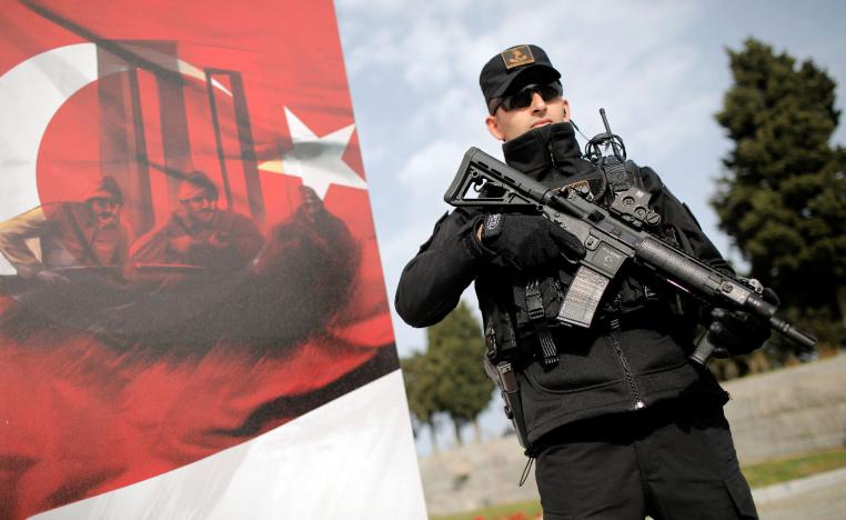 A Turkish gendarme stands guard during an international service marking the 104th anniversary of the WWI battle of Gallipoli at the Turkish memorial in the Gallipoli peninsula in Canakkale