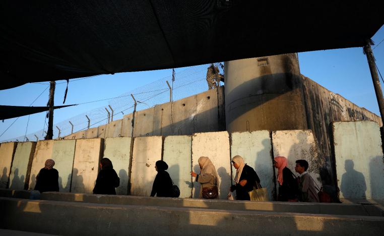 Palestinians make their way along Israel's apartheid wall to attend Friday prayer in Jerusalem's al-Aqsa mosque, at Qalandia checkpoint in the occupied West Bank