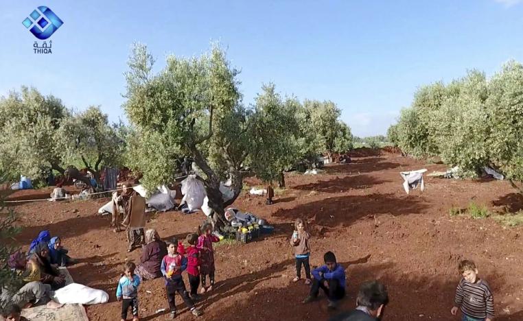 Residents displaced from the latest violence that hit the last rebel stronghold taking refuge in olive orchard near the town of al-Atmeh