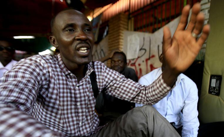 Sudanese man displaced from Darfur, Ahmed Idriss, speaks in a tent for Darfur refugees