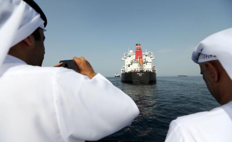 Port officials take a photo of the damaged tanker Andrea Victory at the Port of Fujairah