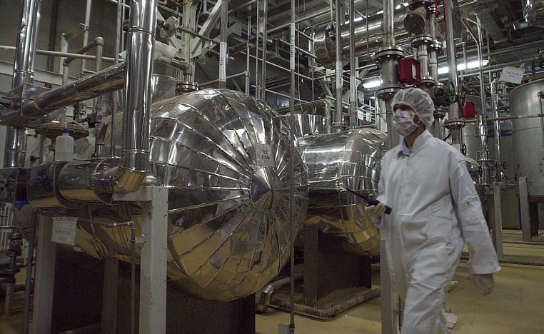  Iranian security official in protective clothing walks through part of the Uranium Conversion Facility just outside the Iranian city of Isfahan