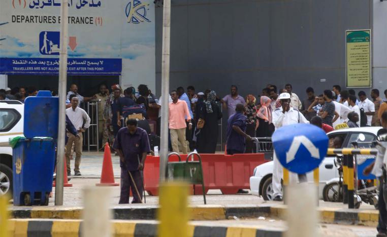 Passengers stranded outside the departure terminal at Khartoum airport