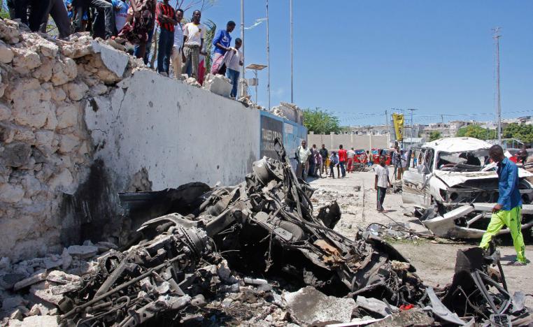 Somalis look at the wreckage after a suicide car bomb attack in the capital Mogadishu