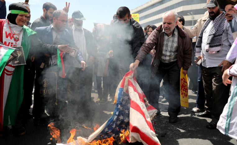Iranians burn a US flag during a rally after Friday prayers in Tehran