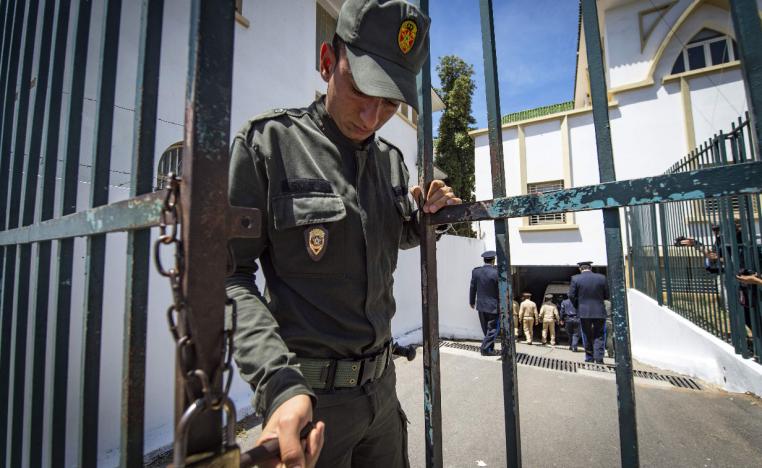 A member of the Moroccan security forces locks the entrance to a court in Sale