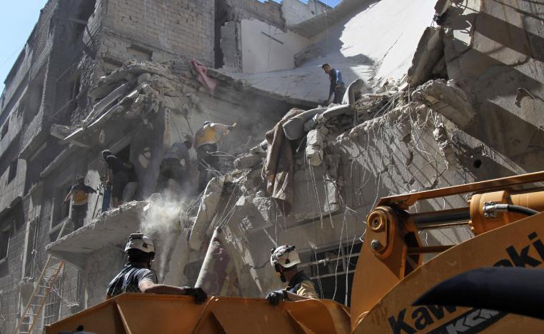 White helmet rescue volunteers and civilians search for survivors amidst the rubble of a building