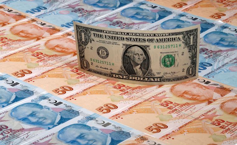 A US dollar banknote is seen on top of 50 and 100 Turkish lira banknotes in this picture illustration in Istanbul