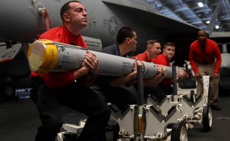 US Navy personnel transport a missile aboard the Nimitz-class aircraft carrier USS Abraham Lincoln in the Persian Gulf